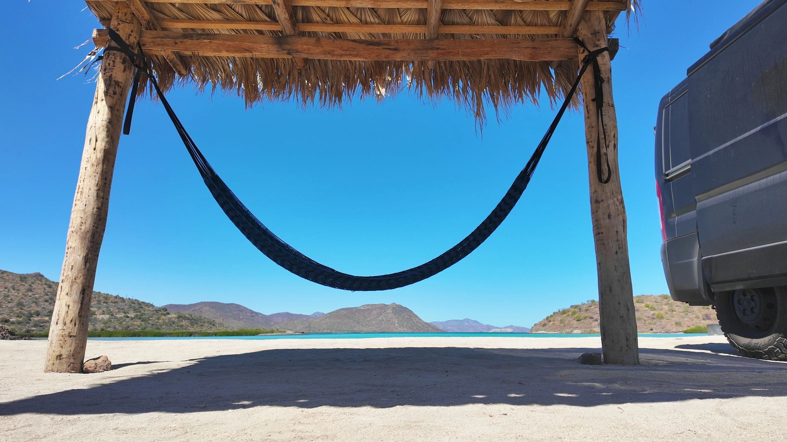 Relaxed beach setting with palapa and hammock in Baja California Sur